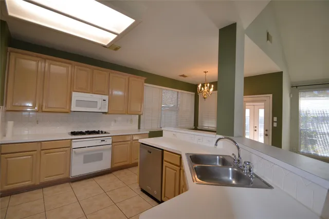 a bathroom with a tub shower sink and mirror