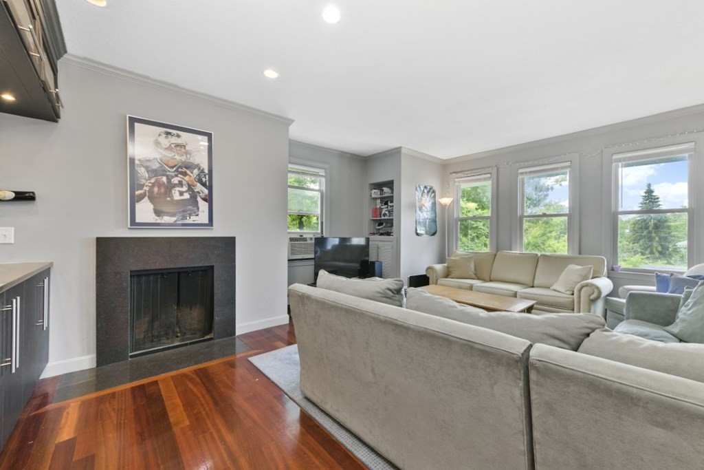 7 Cummings Road, Unit 7 Boston, MA 02135 - Photo 5 of 19 a living room with furniture and a fireplace