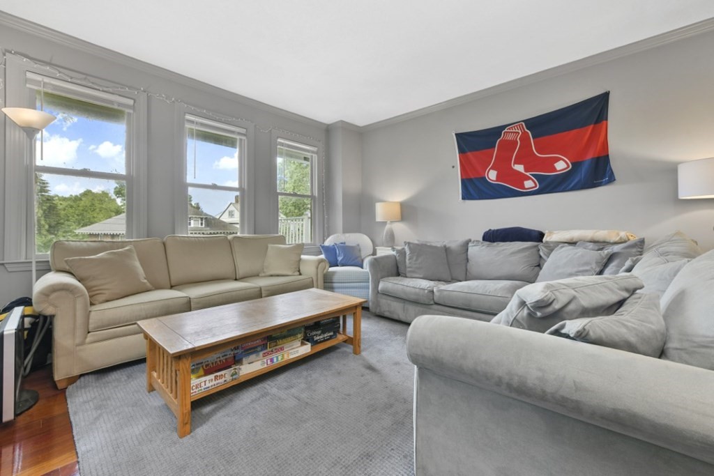 7 Cummings Road, Unit 7 Boston, MA 02135 - Photo 6 of 19 a living room with furniture and a large window