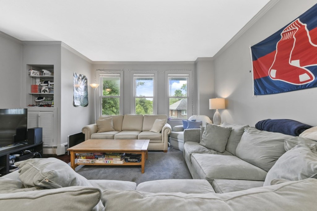 7 Cummings Road, Unit 7 Boston, MA 02135 - Photo 8 of 19 a living room with furniture and a flat screen tv