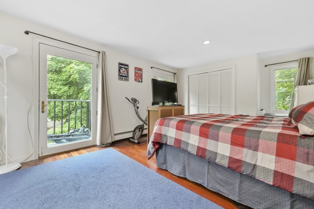 7 Cummings Road, Unit 7 Boston, MA 02135 - Photo 10 of 19 a bedroom with a bed and glass door