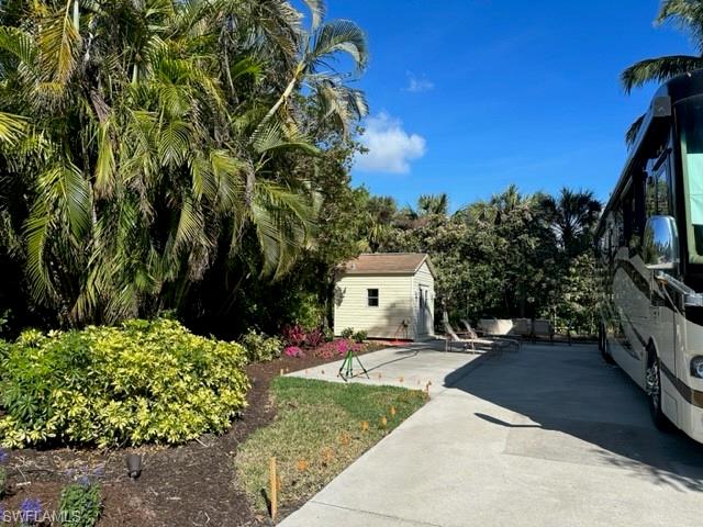 4995 Coach Lane Naples, FL 34114 - Photo 4 of 4 a pathway of a house with a yard