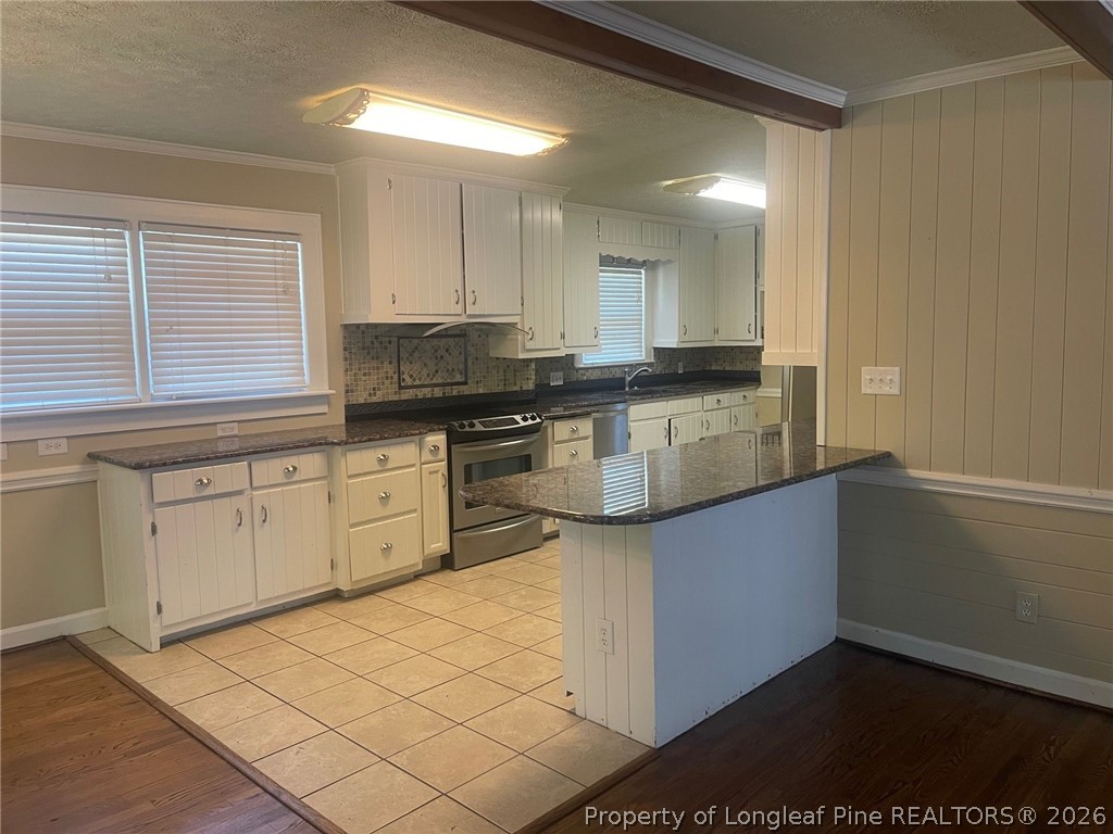 2515 Fort Bragg Road Fayetteville, NC 28303 - Photo 8 of 23 a kitchen with stainless steel appliances granite countertop a stove a sink and a microwave