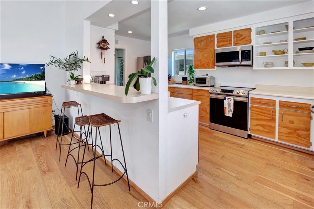 5821 Sierra Cielo Road Irvine, CA 92603 - Photo 13 of 26 a kitchen with stainless steel appliances a stove top oven a sink a counter space and cabinets