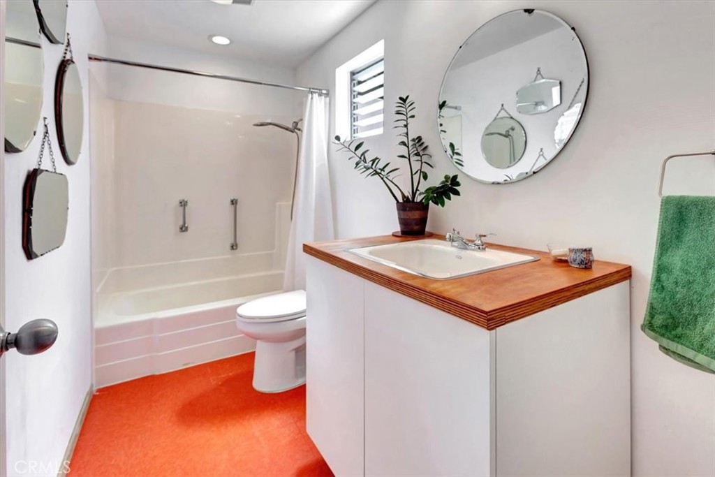 5821 Sierra Cielo Road Irvine, CA 92603 - Photo 18 of 26 a bathroom with a sink a toilet and a mirror