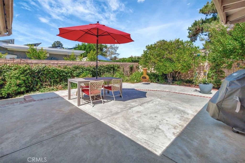 5821 Sierra Cielo Road Irvine, CA 92603 - Photo 4 of 26 a view of a tables and chairs under an umbrella in the patio