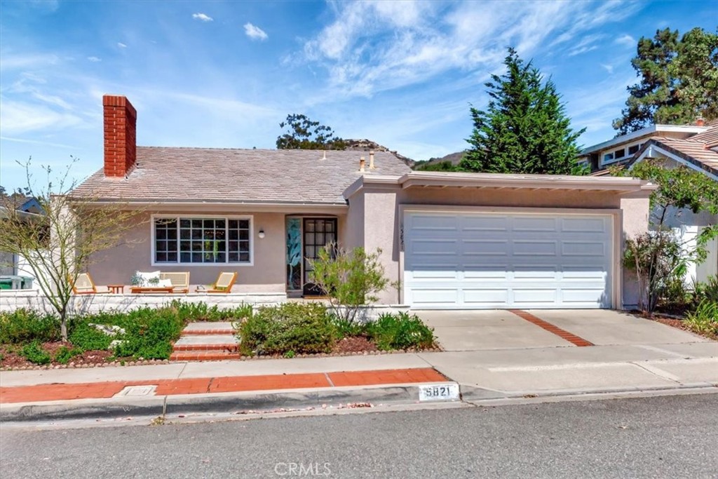5821 Sierra Cielo Road Irvine, CA 92603 - Photo 5 of 26 a front view of a house with a yard and a garage