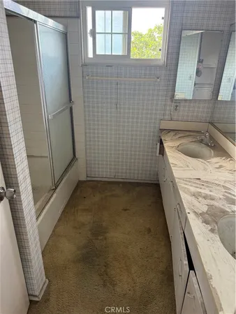 a bathroom with a sink a toilet a window and vanity