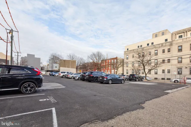 a view of street with cars and a buildings