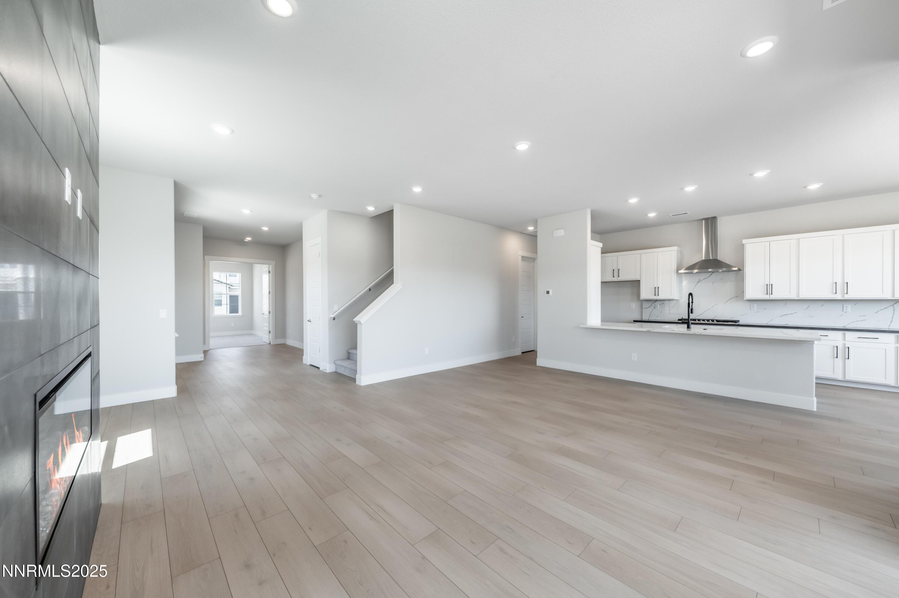 1357 Silver View Circle Sparks, NV 89436 - Photo 14 of 44 a view of an empty room and kitchen with wooden floor