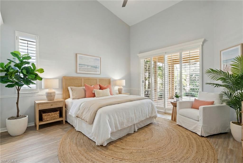 20751 Rivers Ford Estero, FL 33928 - Photo 6 of 36 Bedroom with high vaulted ceiling, access to outside, light wood finished floors, and a ceiling fan