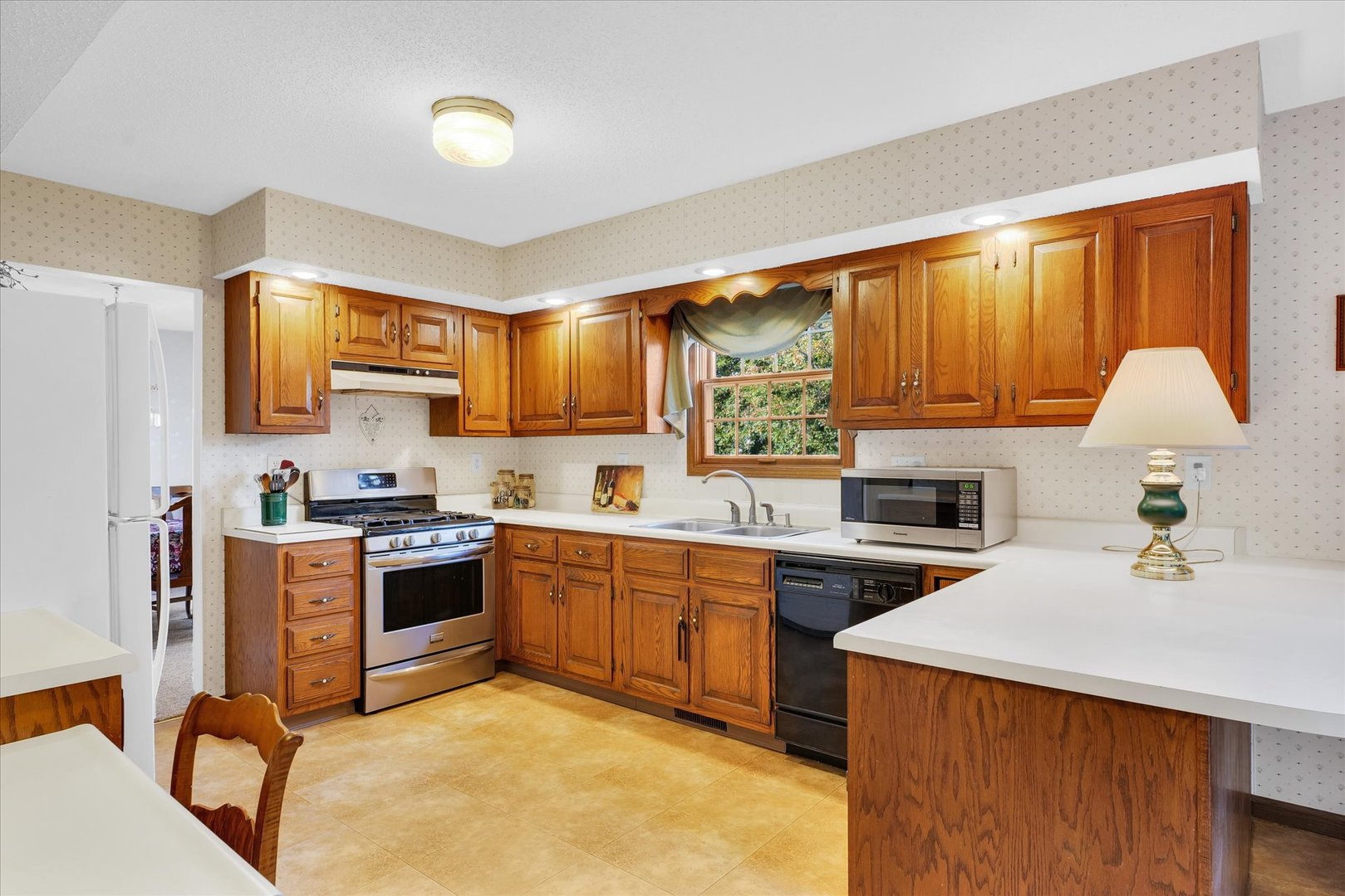 2011 O Donnell Drive Champaign, IL 61821 - Photo 14 of 43 a kitchen with granite countertop a sink cabinets stainless steel appliances and a window