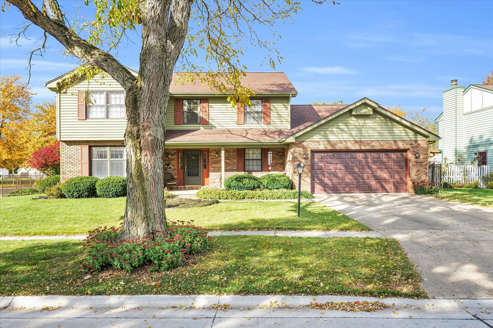 2011 O Donnell Drive Champaign, IL 61821 - Photo 2 of 43 a front view of a house with a yard and potted plants