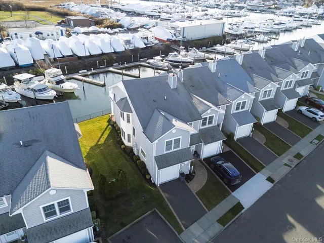 a bathroom with a granite countertop toilet a sink a mirror and a shower