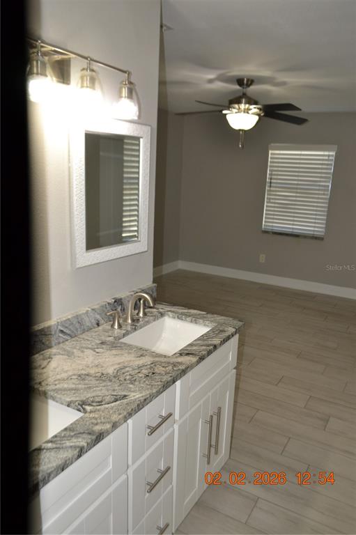 6204 West Knights Griffin Road Plant City, FL 33565 - Photo 13 of 19 a bathroom with a granite countertop sink and a mirror