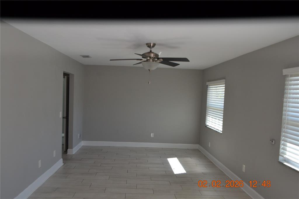 6204 West Knights Griffin Road Plant City, FL 33565 - Photo 2 of 19 a view of a livingroom with a ceiling fan and window