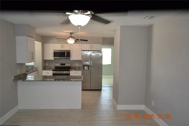 a kitchen with stainless steel appliances a refrigerator a stove a sink and dishwasher