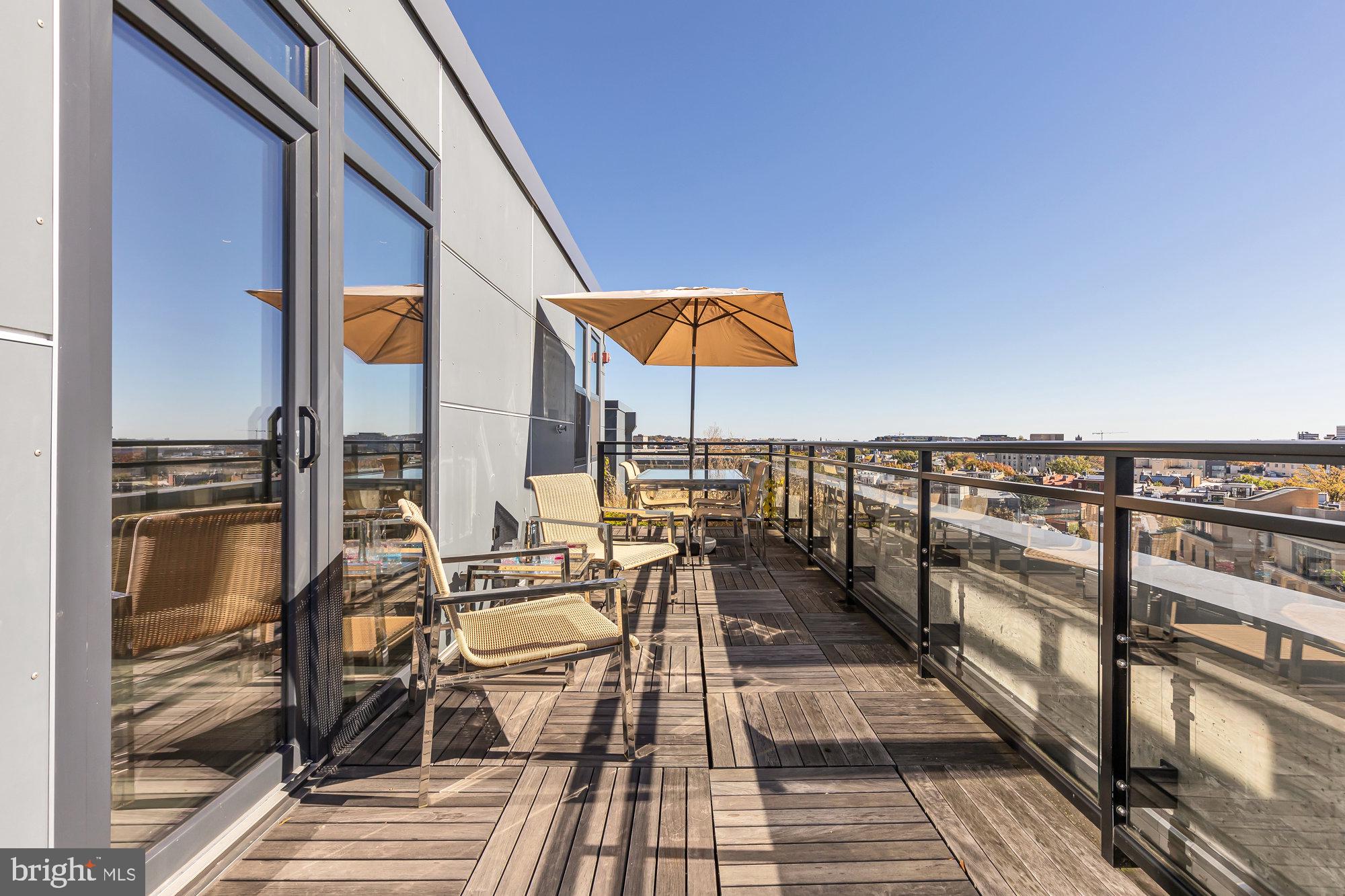 1427 Rhode Island Avenue Northwest, Unit PH01 Washington, DC 20005 - Photo 11 of 39 a view of balcony with chairs and wooden floor