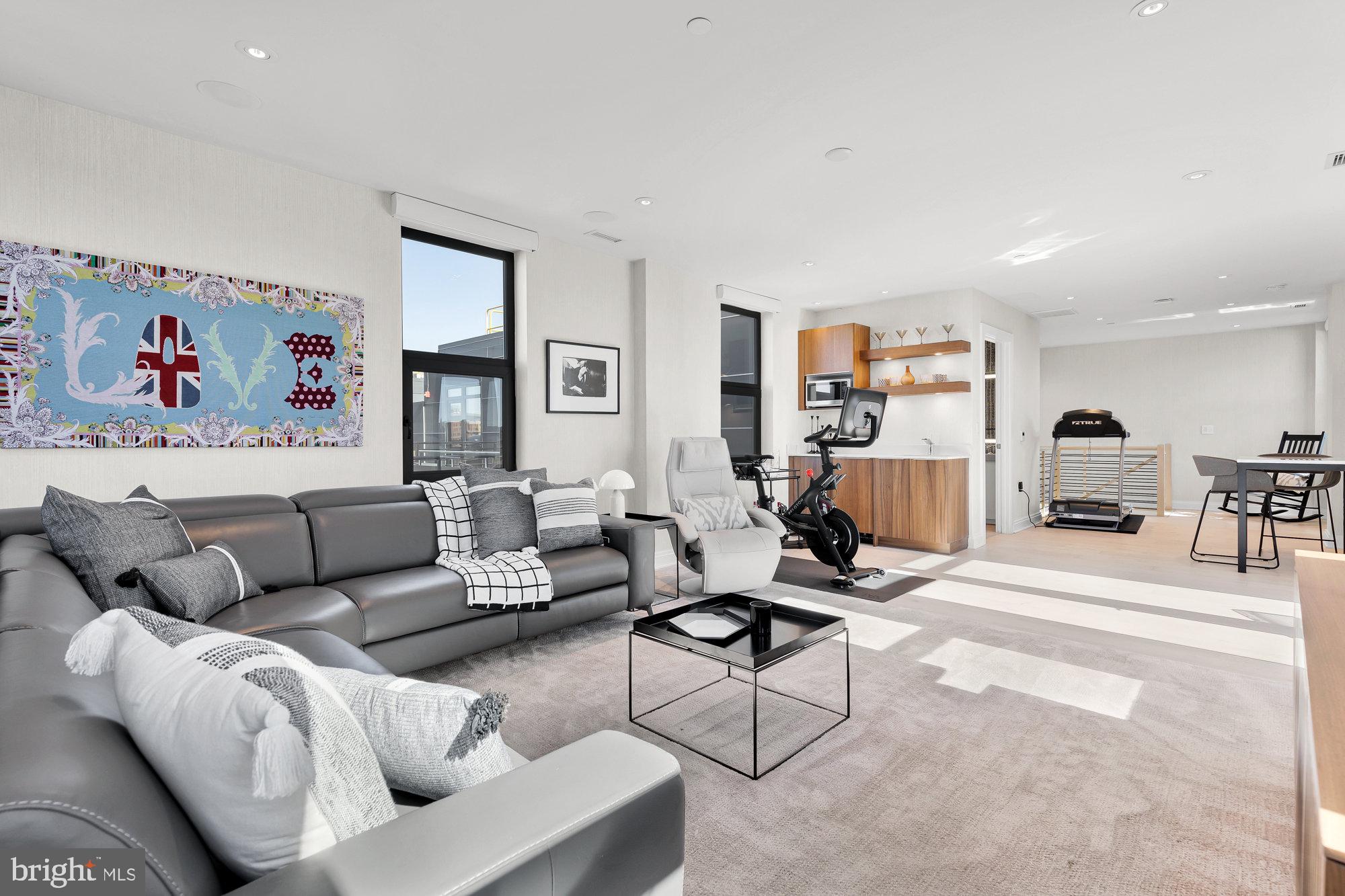 1427 Rhode Island Avenue Northwest, Unit PH01 Washington, DC 20005 - Photo 16 of 39 a living room with furniture and a large window