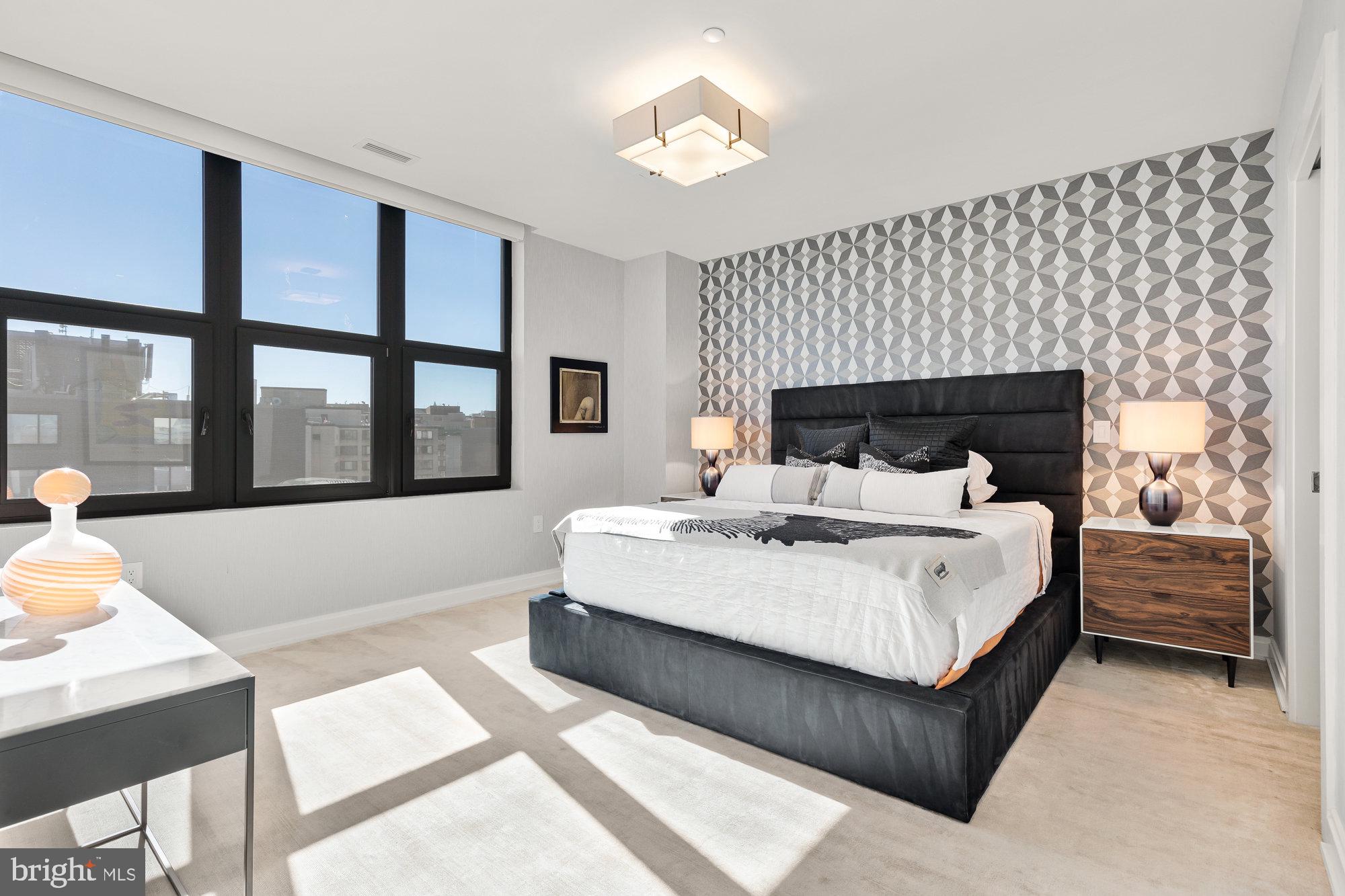 1427 Rhode Island Avenue Northwest, Unit PH01 Washington, DC 20005 - Photo 19 of 39 a bed sitting in a bedroom next to a window