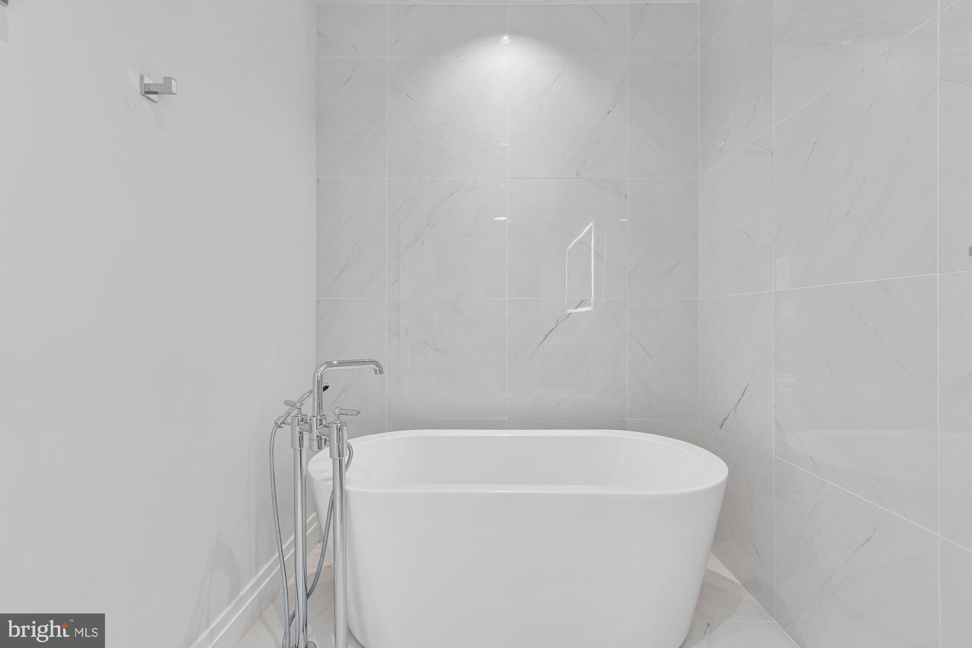 1427 Rhode Island Avenue Northwest, Unit PH01 Washington, DC 20005 - Photo 21 of 39 a bathroom with a bathtub