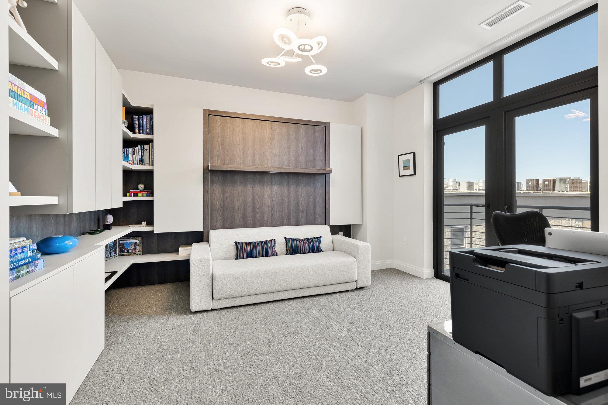 1427 Rhode Island Avenue Northwest, Unit PH01 Washington, DC 20005 - Photo 23 of 39 a living room with furniture and a flat screen tv