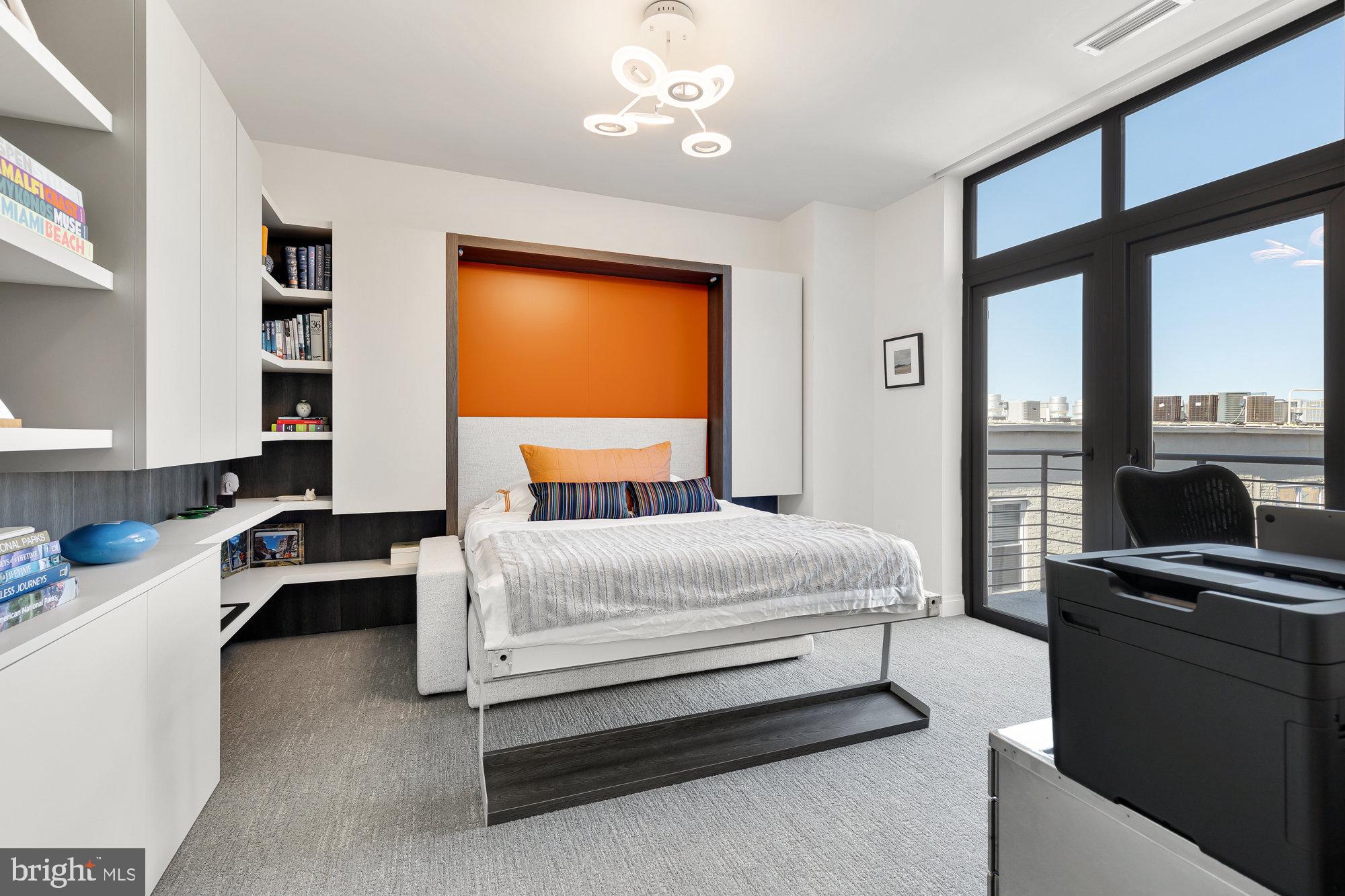 1427 Rhode Island Avenue Northwest, Unit PH01 Washington, DC 20005 - Photo 24 of 39 a bedroom with a bed and a flat screen tv