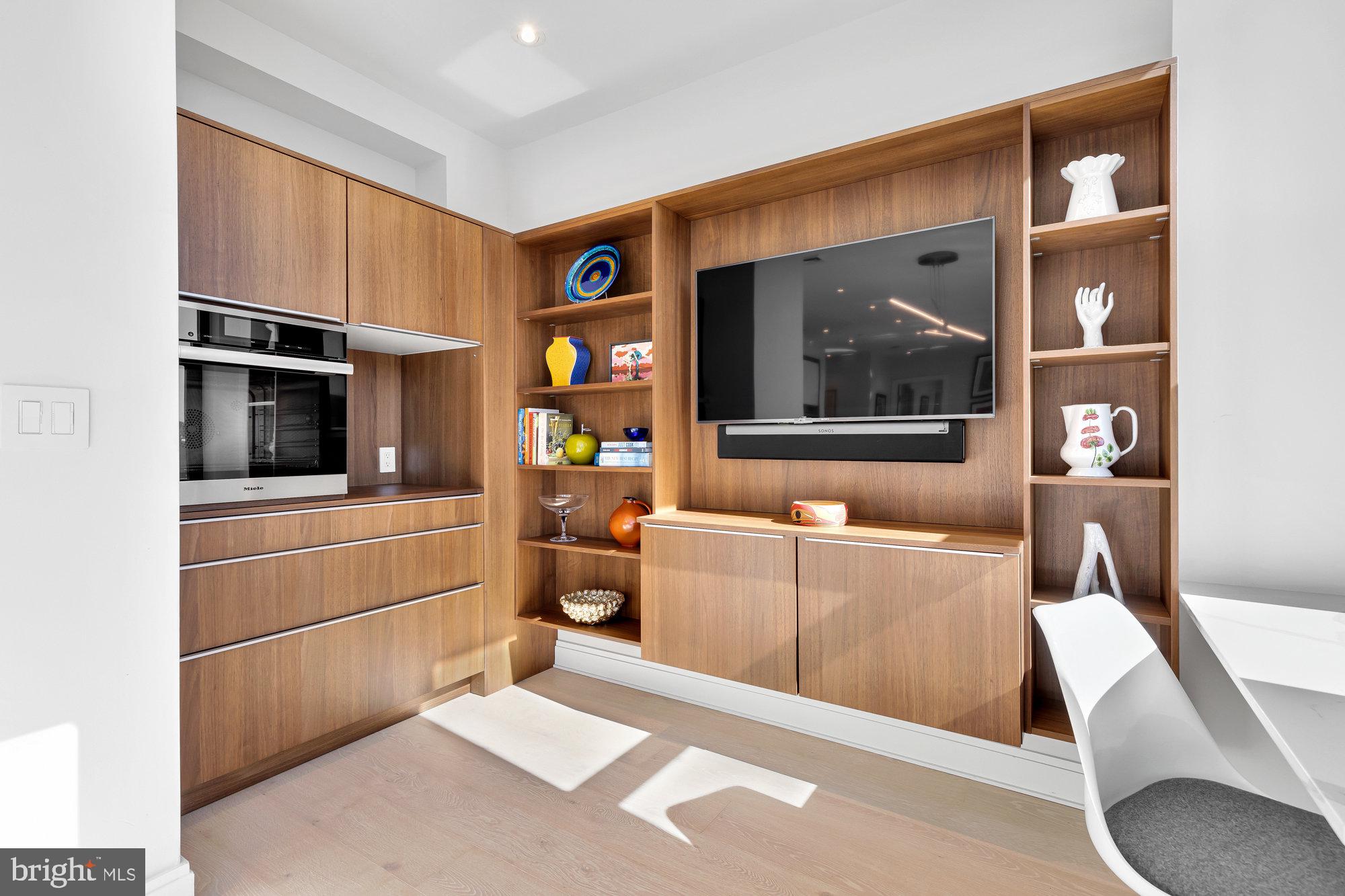 1427 Rhode Island Avenue Northwest, Unit PH01 Washington, DC 20005 - Photo 4 of 39 a living room with furniture and a flat screen tv