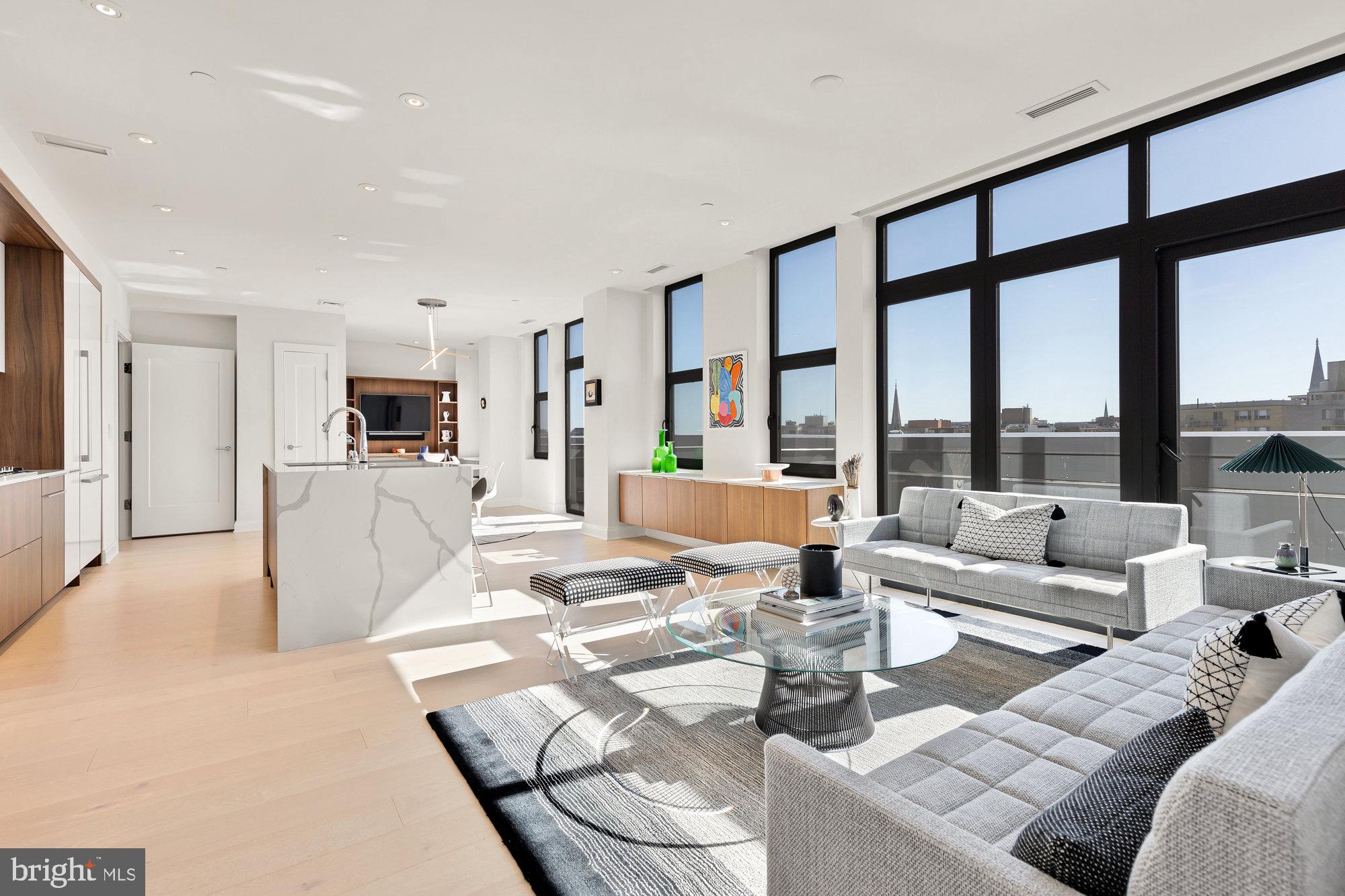 1427 Rhode Island Avenue Northwest, Unit PH01 Washington, DC 20005 - Photo 7 of 39 a living room with furniture and a large window with kitchen view