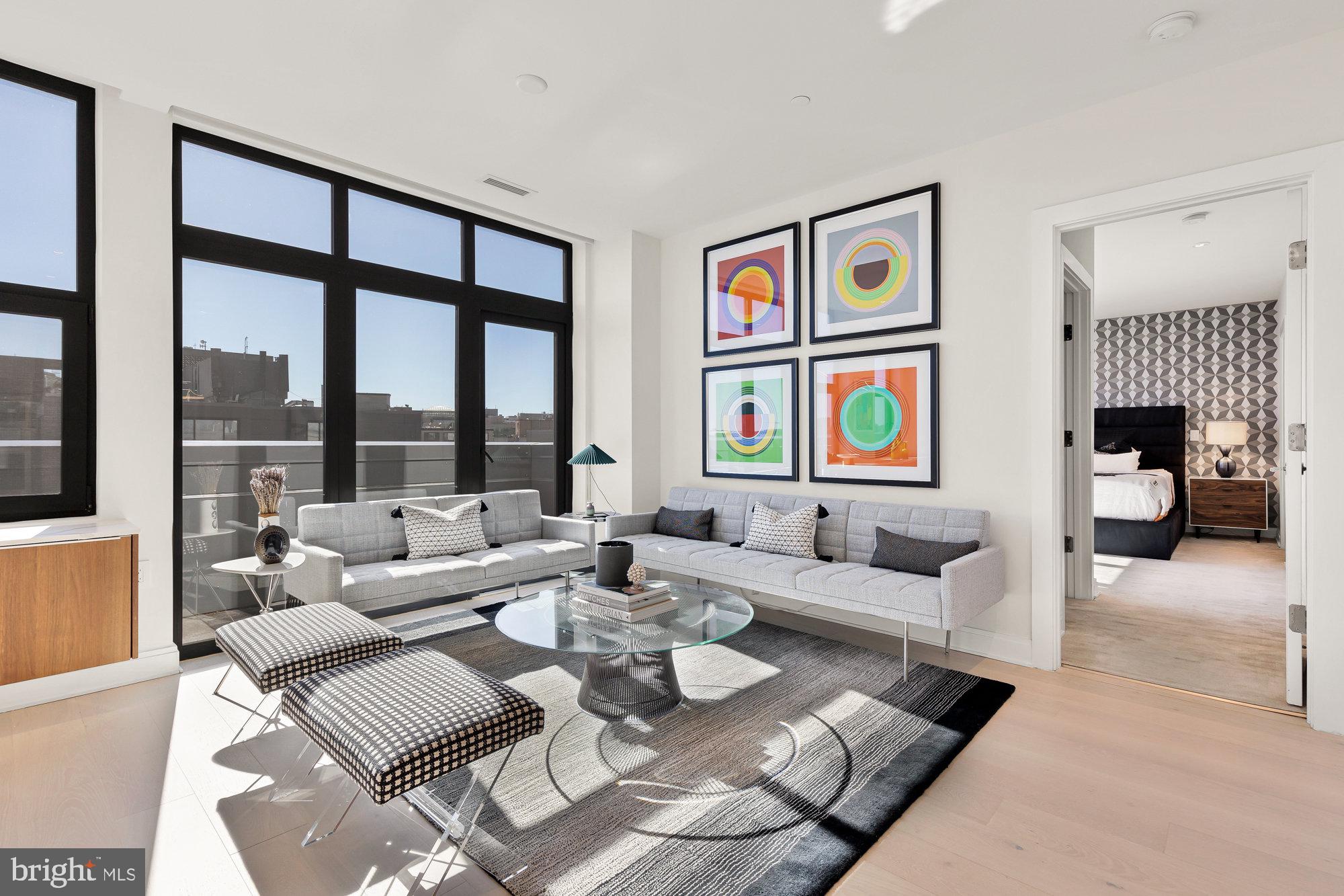 1427 Rhode Island Avenue Northwest, Unit PH01 Washington, DC 20005 - Photo 8 of 39 a living room with furniture and large windows