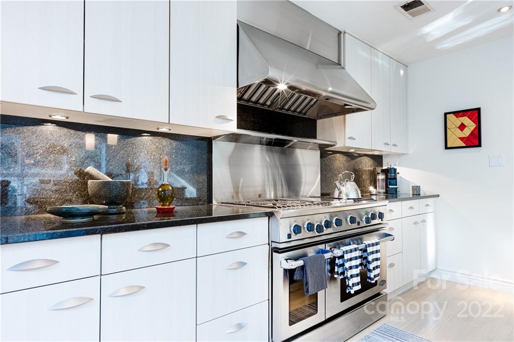 3234 Mountainbrook Road Charlotte, NC 28210 - Photo 21 of 48 a kitchen with stainless steel appliances granite countertop a stove and cabinets