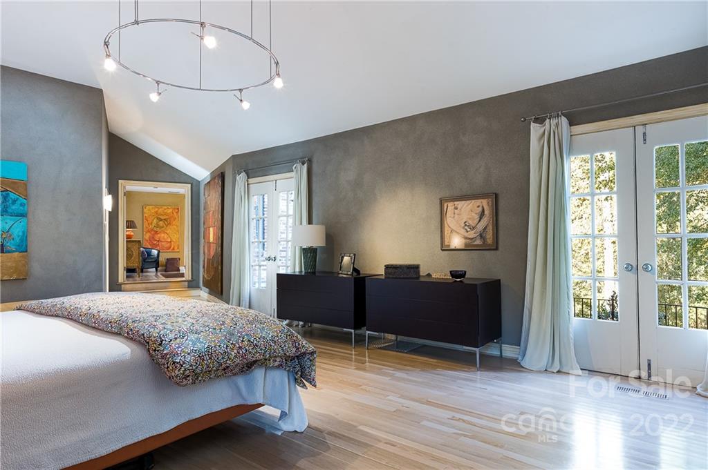 3234 Mountainbrook Road Charlotte, NC 28210 - Photo 31 of 48 a bedroom with a bed and wooden floor