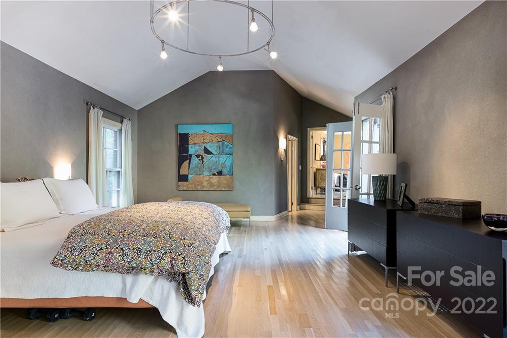 3234 Mountainbrook Road Charlotte, NC 28210 - Photo 32 of 48 a bedroom with a bed and wooden floor