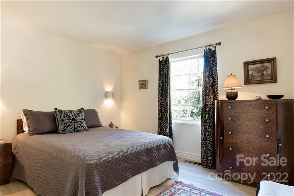 3234 Mountainbrook Road Charlotte, NC 28210 - Photo 37 of 48 a bedroom with a bed and wooden floor