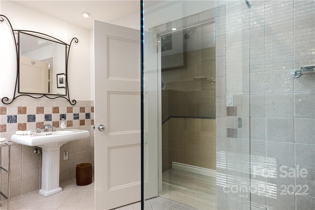3234 Mountainbrook Road Charlotte, NC 28210 - Photo 40 of 48 a bathroom with a sink shower and a mirror