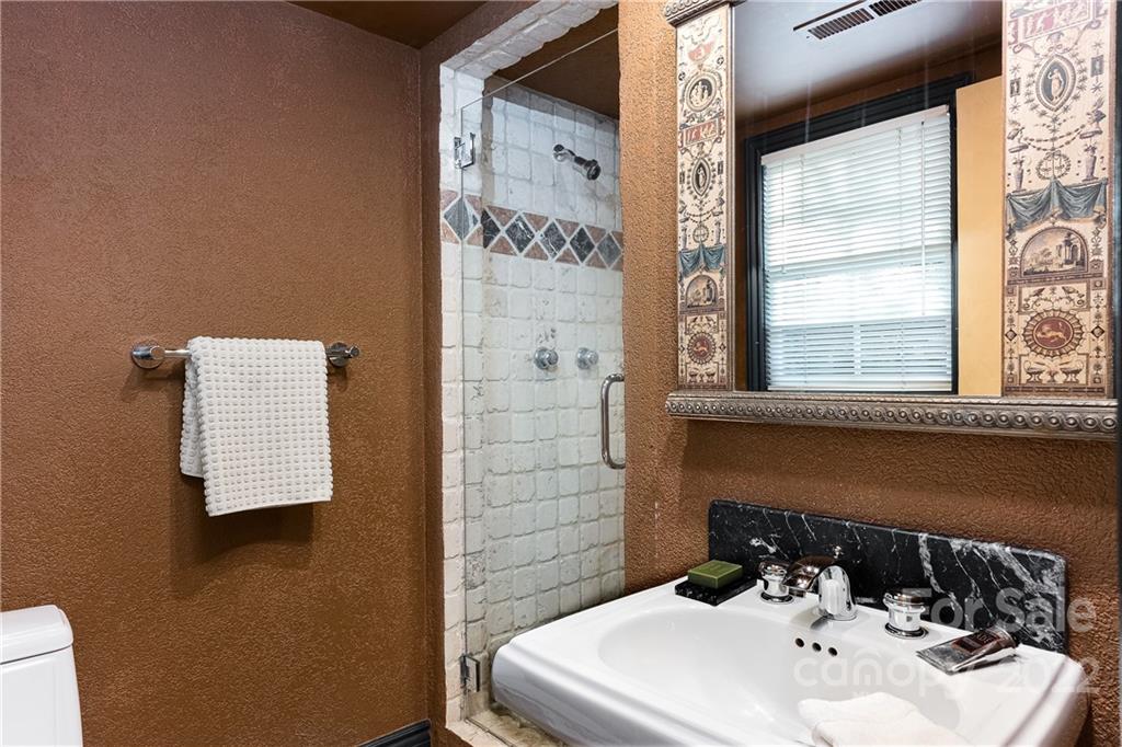 3234 Mountainbrook Road Charlotte, NC 28210 - Photo 44 of 48 a bathroom with a sink and a mirror
