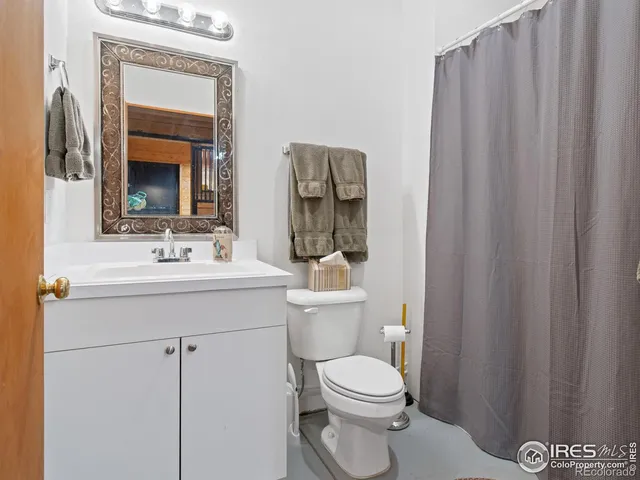 a bathroom with a toilet a sink and a mirror