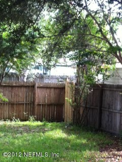 206 Orchis Road St. Augustine, FL 32086 - Photo 8 of 8 a view of backyard with wooden fence and a large tree