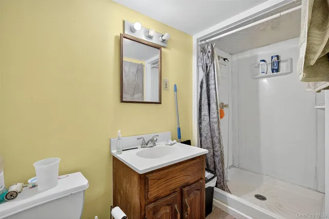 a view of a house with a wooden fence