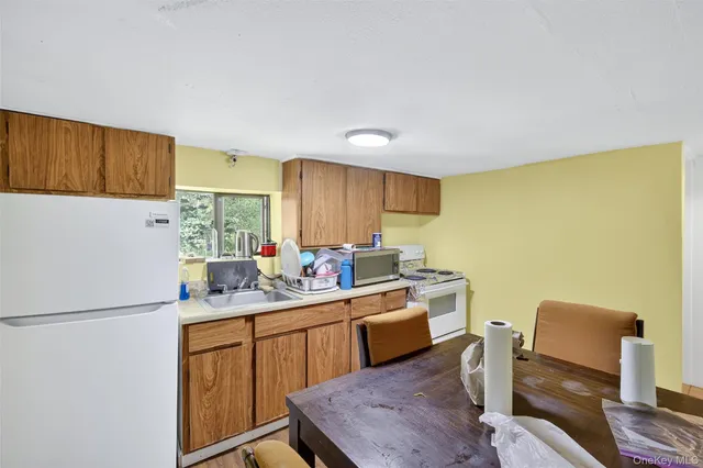 a kitchen that has a sink and a refrigerator in it