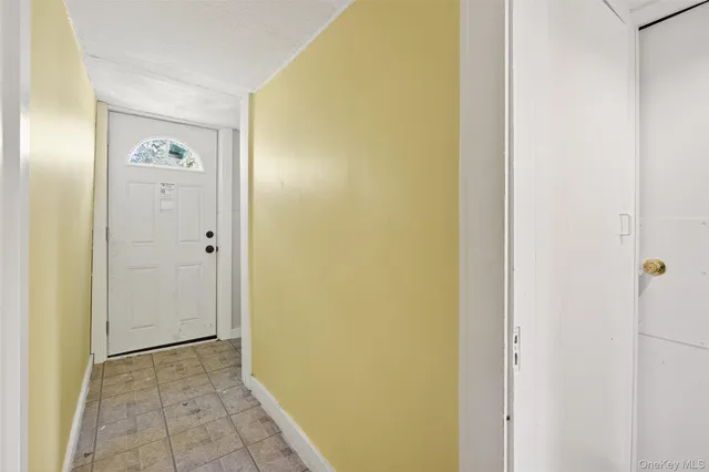 a view of a workspace with wooden floor and a window