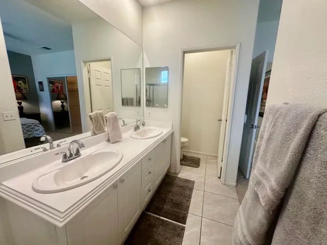 a bathroom with a sink a toilet and a mirror