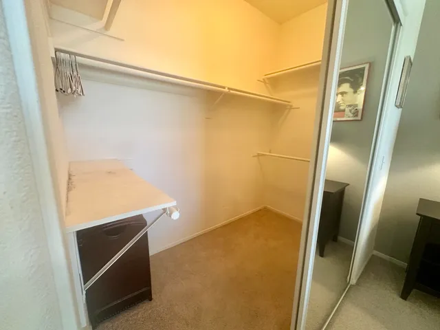 a bedroom with a bed and painting on the wall