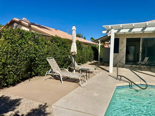 a view of swimming pool with a table and chairs