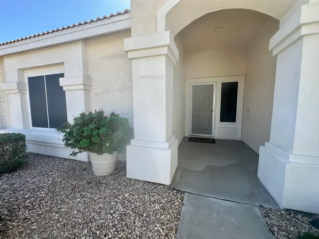 a view of a back yard of the house and potted plants