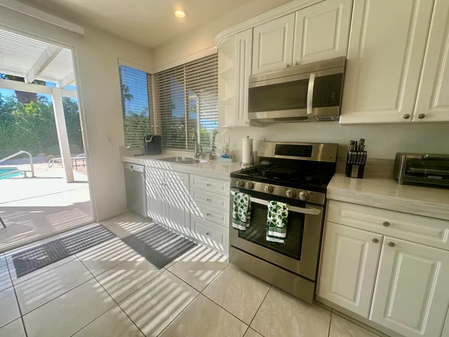 a view of a house with backyard porch and garden
