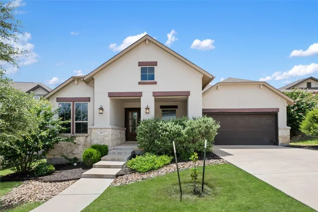 a front view of a house with a garden and plants
