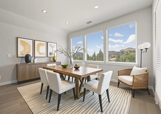 a view of a dining room with furniture large windows and wooden floor