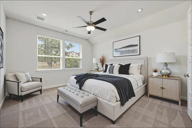 a living room with furniture a table and a potted plant