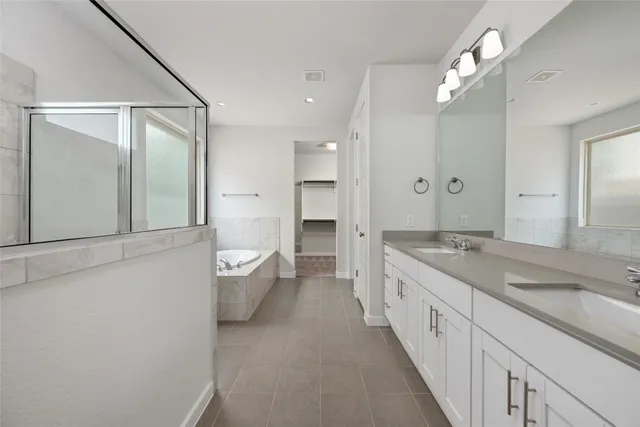 a spacious bedroom with a bed and a couch